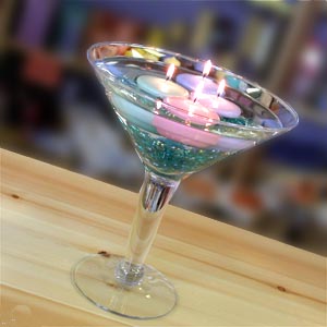 centro de mesa de copa de martini con cuentas de colores y velas flotantes